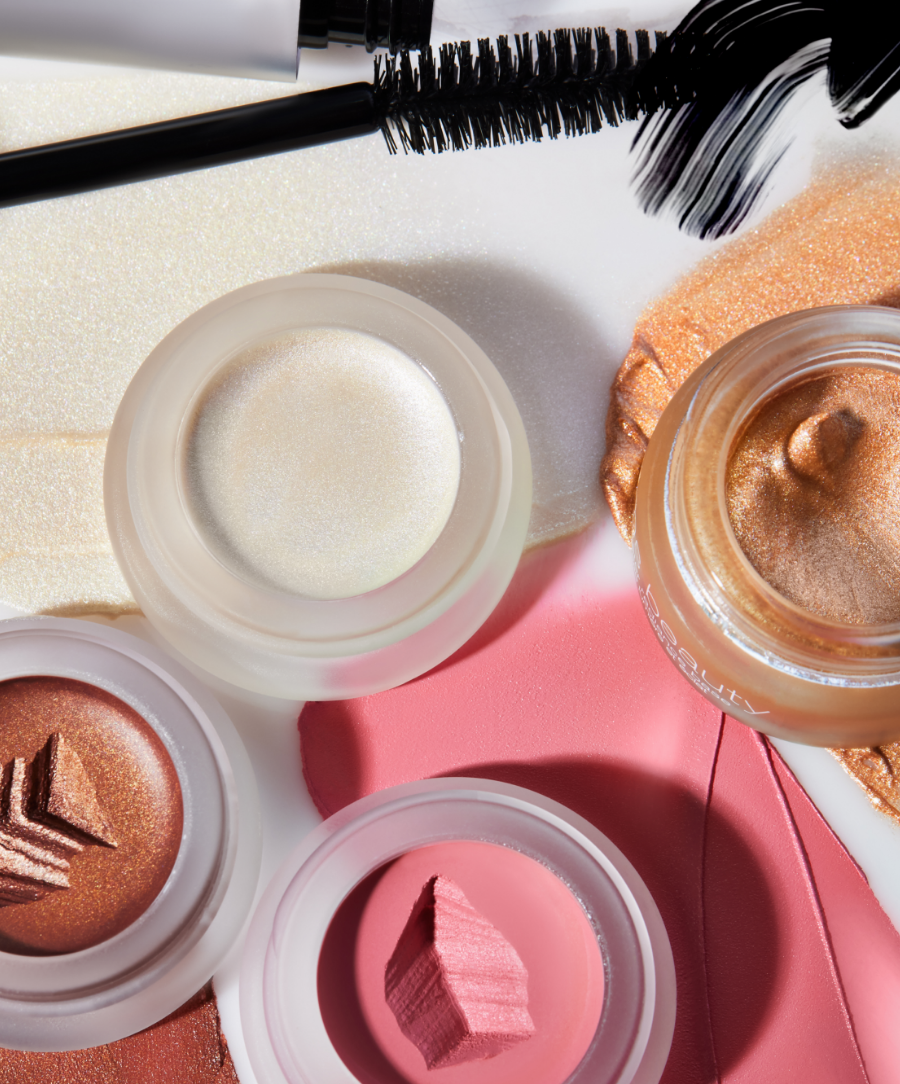 Close-up of Living Luminizer (deluxe mini): an ultra-sheer, lit-from-within, natural glow. “Demure” Lip2cheek (deluxe mini): a seductive coral pink with lush golden undertones. Buriti Bronzer (deluxe mini): a warm, sun-kissed finish. “Rich in Radiance” Master Radiance Base (deluxe mini): a rose gold incandescence. Straight Up Volumizing Peptide Mascara (full-size): HD black.